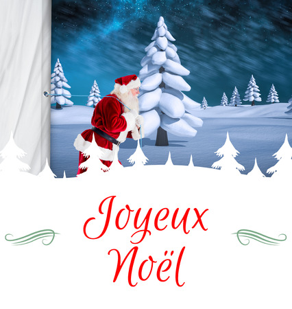 Composite image of santa claus pulling rope against Christmas greeting cardの写真素材