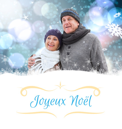 mature winter couple against Christmas greeting cardの写真素材