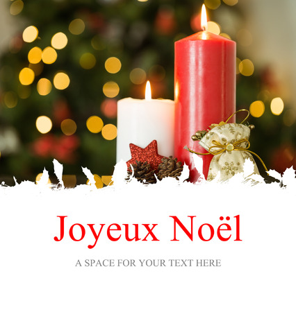Joyeux noel against focus on christmas candles and decorationsの写真素材