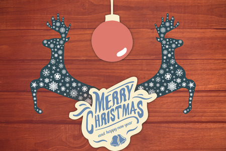 Merry christmas message with a ball against overhead of wooden planksの写真素材