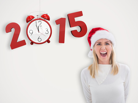Stressed blonde in santa hat against grey background with vignette