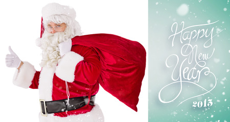 Positive santa with his sack and thumbs up against green vignetteの写真素材