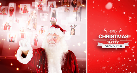 santa pointing to christmas people collage against red vignetteの写真素材