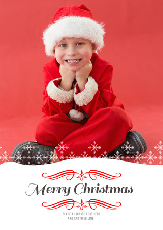 Cute little boy in santa costume against borderの写真素材