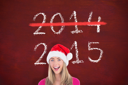Festive blonde holding large poster  against deskの写真素材