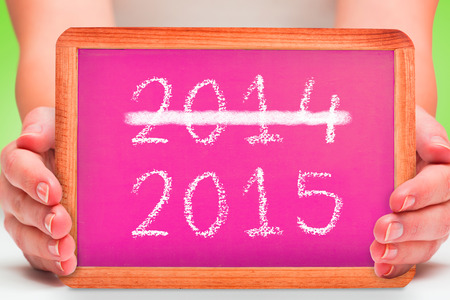 Females hands showing pink board against green vignetteの写真素材