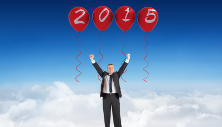 Mature businessman cheering with arms up against blue sky over clouds