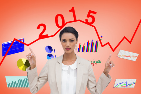 Serious businesswoman with hands up against orange
