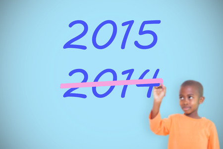 Cute boy smiling and writing against blue background with vignetteの写真素材