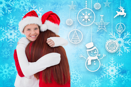 Mother and daughter with gift against blue snow flake pattern designの写真素材