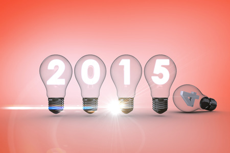 2015 with light bulb against orangeの写真素材