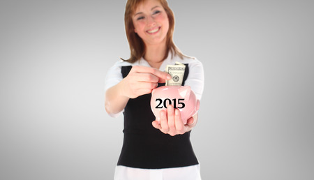 Woman putting money in a Piggy Bank against grey vignette