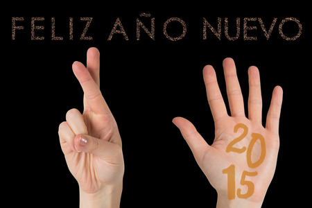 Hands against glittering feliz ano nuevo