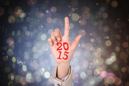 Businesswoman pointing against dark abstract light spot designの写真素材