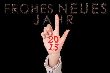 Businesswoman pointing against glittering frohes neues jahrの写真素材