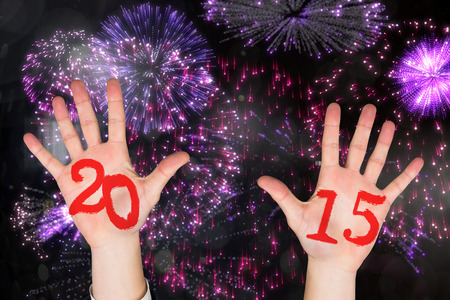 Hands against colourful fireworks exploding on black backgroundの写真素材