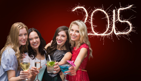 Friends with drinks against red background with vignetteの写真素材