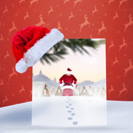 Santa delivery presents to village against orange reindeer patternの写真素材