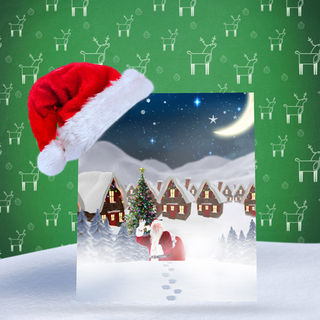 Santa delivery presents to village against green reindeer patternの写真素材