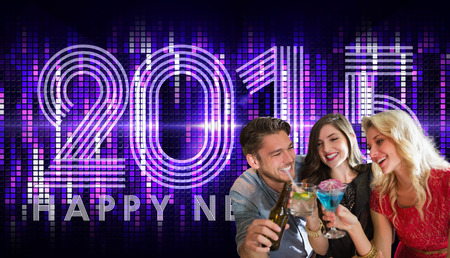 Friends with drinks against 2015 in colourful lights