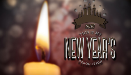 New years resolution against candle burning against festive backgroundの写真素材