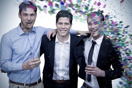 Handsome friends having a drink together against colour curveの写真素材