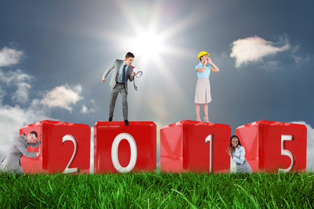 Portrait of a young businessman pushing a wall against skyの写真素材