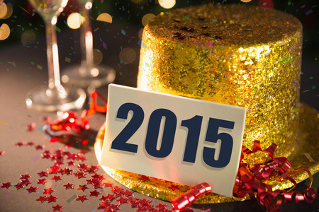 2015 card on table set for party with gold hat and champagne
