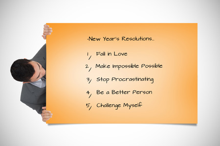 Businessman looking around the corner against orange cardの写真素材