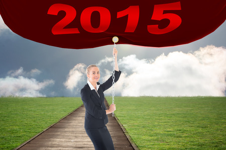 Businesswoman pulling a chain against path on grass