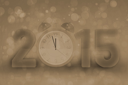 2015 with alarm clock against pink abstract light spot designの写真素材