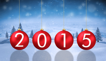 2015 baubles against snowy landscape with fir treesの写真素材