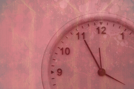 Clock against red paint splashed surfaceの写真素材