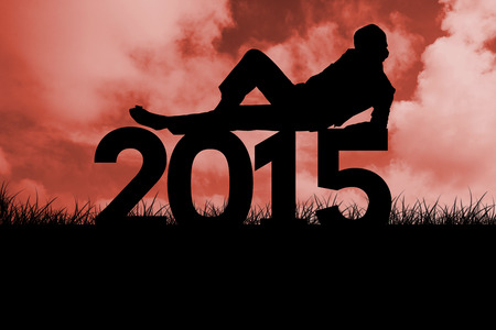 Silhouette of a man against red sky over grassの写真素材