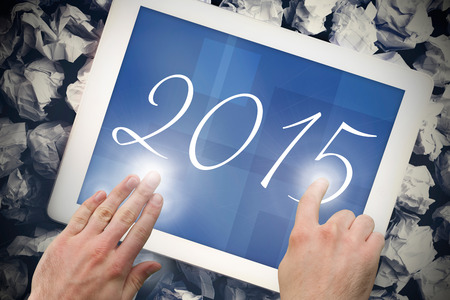 2015 against hands touching tablet screenの写真素材