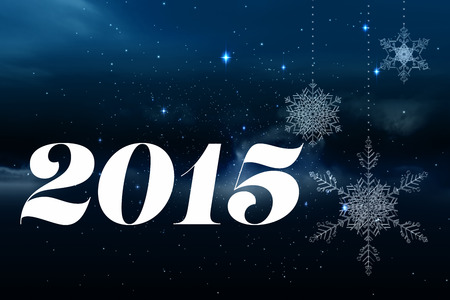 2015 against snowflakes hanging against starry sky