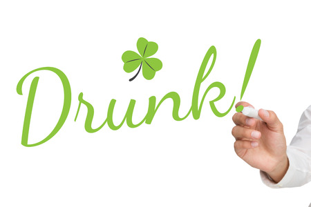 Businessman about to write something against shamrockの写真素材