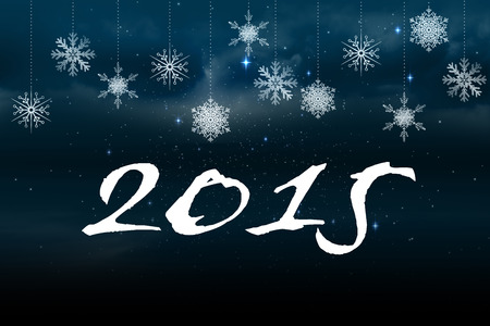 2015 against snowflakes hanging against blue backgroundの写真素材