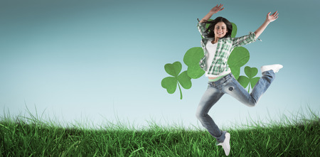 Happy brunette against cloudy sky with sunshineの写真素材