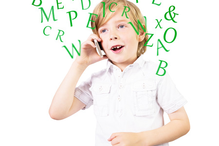 Cute boy talking on smartphone against lettersの写真素材