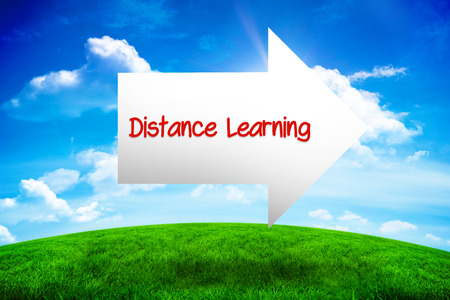 The word distance learning and arrow against green hill under blue sky