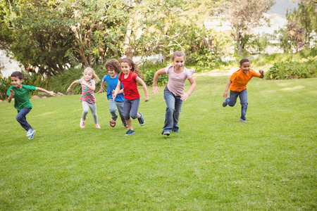 Children running on the grass in a race Children running on the grass in a race