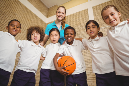 Students and teacher looking at the camera at the elementary schoolの写真素材