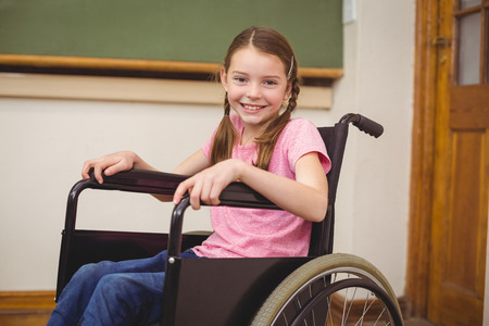 Disabled pupil smiling at camera at the elementary schoolの写真素材