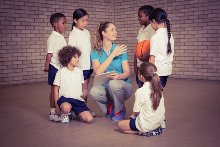 Teacher talking with sports students at the elementary school