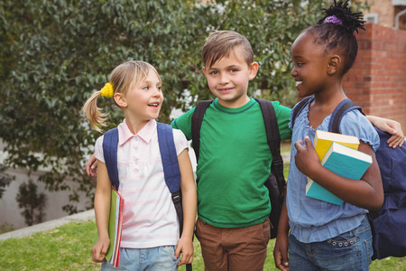 Smiling students looking at the camera on the elementary school grounds