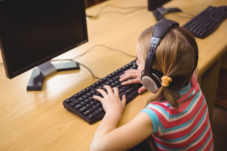 Cute pupil in computer class at the elementary school