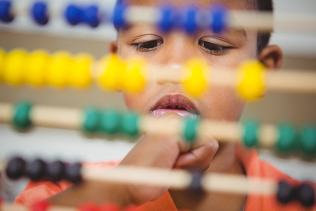 Student using a maths abacus at the elementary schoolの写真素材