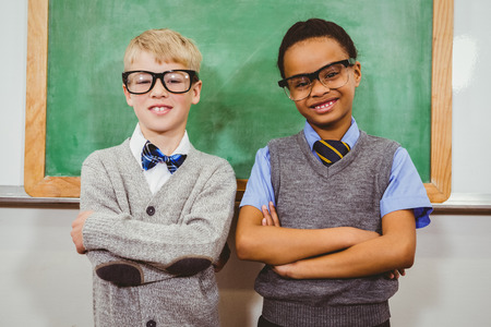 Smart students standing in front of a blackboard at the elementary schoolの写真素材