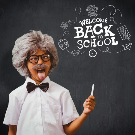 Pupil dressed up in wig against blackboard